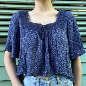 Blue floral flowy Hollister shirt with tassel ties in front and knit detailing
